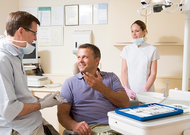 Dental patient talking with dentist