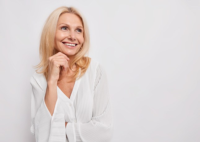 Happy, smiling mature woman in white blouse