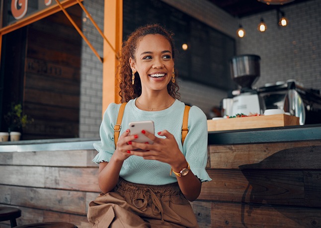 Smiling woman sitting on barstool at restaurant