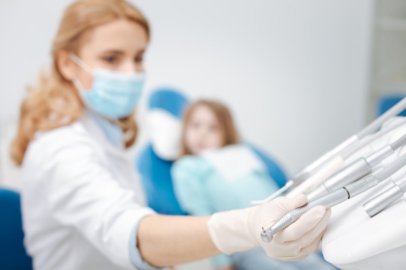 Dental hygienist treats patient